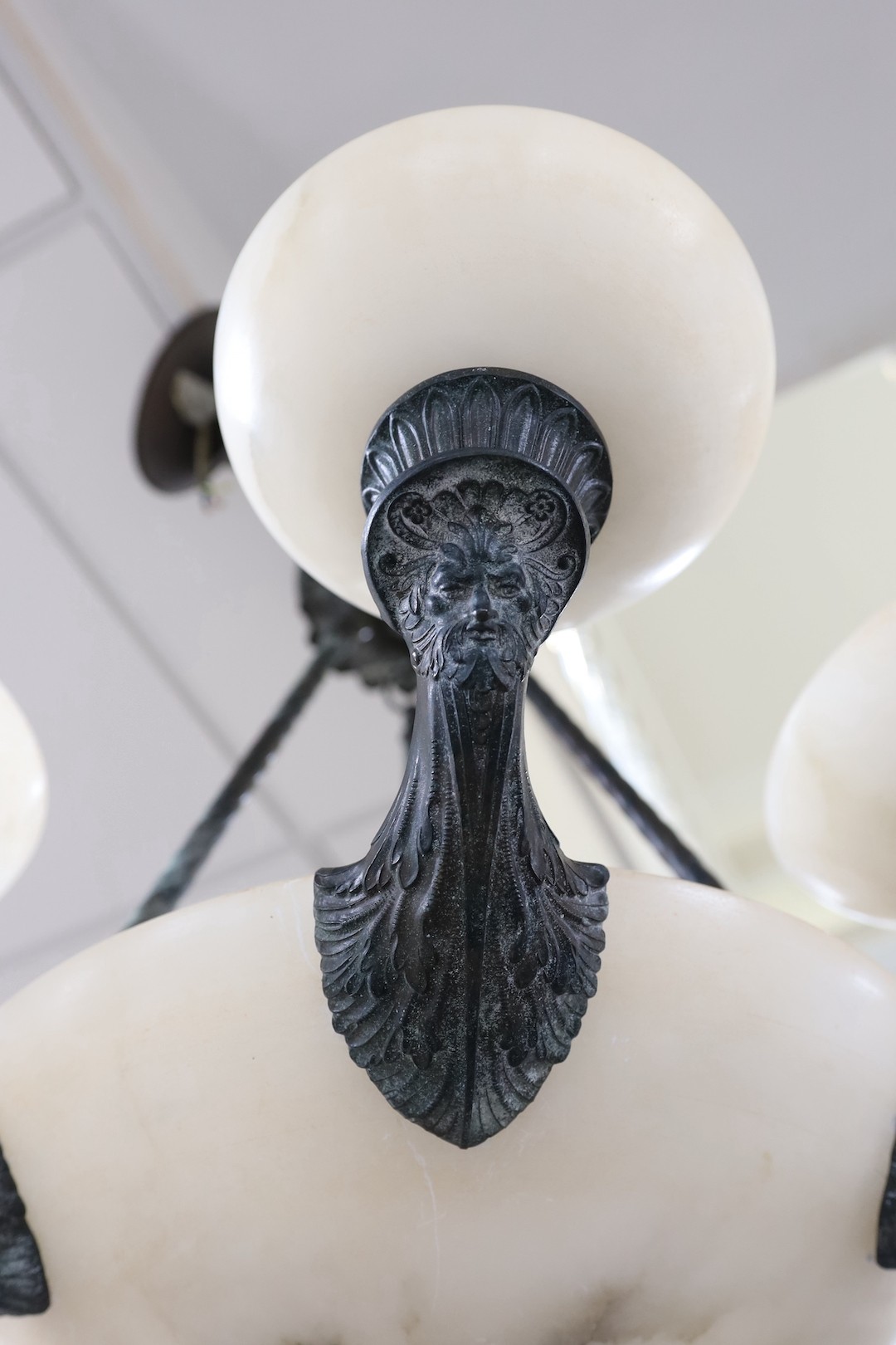 An Empire style bronze and an alabaster chandelier